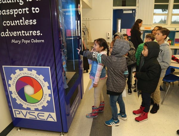 Students use Pleasant Valley Book Vending Machine