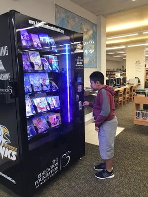 Student with Beadle Lake Elementary Book Vending Machine