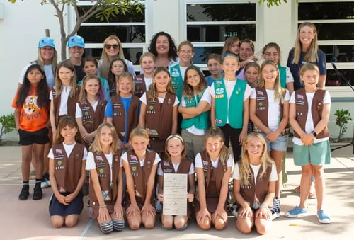 Girl Scout Troop 2383 poses for a photo at Newport Elementary with Principal Amanda Estrada and other faculty on Friday. (Eric Licas)