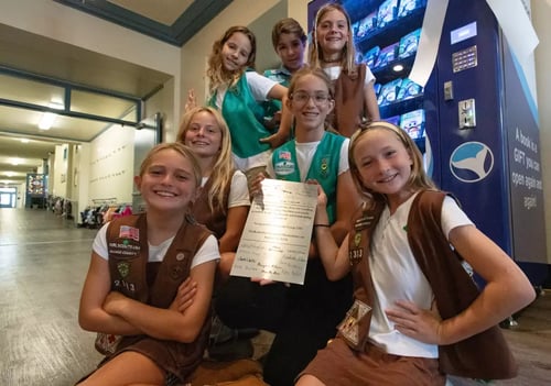 Members of Girl Scout Troop 2383 hold a plaque commemorating their donation of a book vending machine to Newport Elementary School on Friday. (Eric Licas)