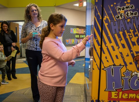 Higgins School Book Vending Machine Teacher Student aligns with SEL